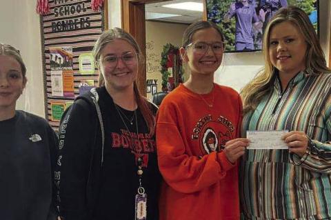 Addilyn Newton, Brielle Haynes, and Crosby Nuncio are headed to STEAM camp this summer at Southwestern Oklahoma State University. Also pictured is Paige Jacobs presenting a check from Xi Alpha Chi. Courtesy photo