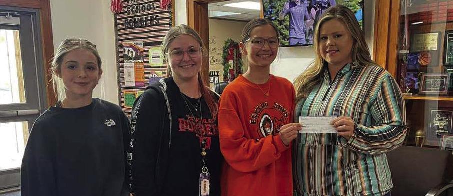 Addilyn Newton, Brielle Haynes, and Crosby Nuncio are headed to STEAM camp this summer at Southwestern Oklahoma State University. Also pictured is Paige Jacobs presenting a check from Xi Alpha Chi. Courtesy photo
